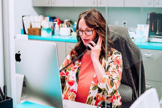 Cindy-Warren-talking-on-phone-at-front-desk