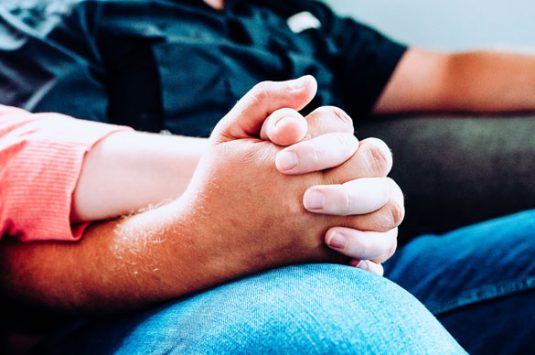 husband-and-wife-sitting-and-holding-hands
